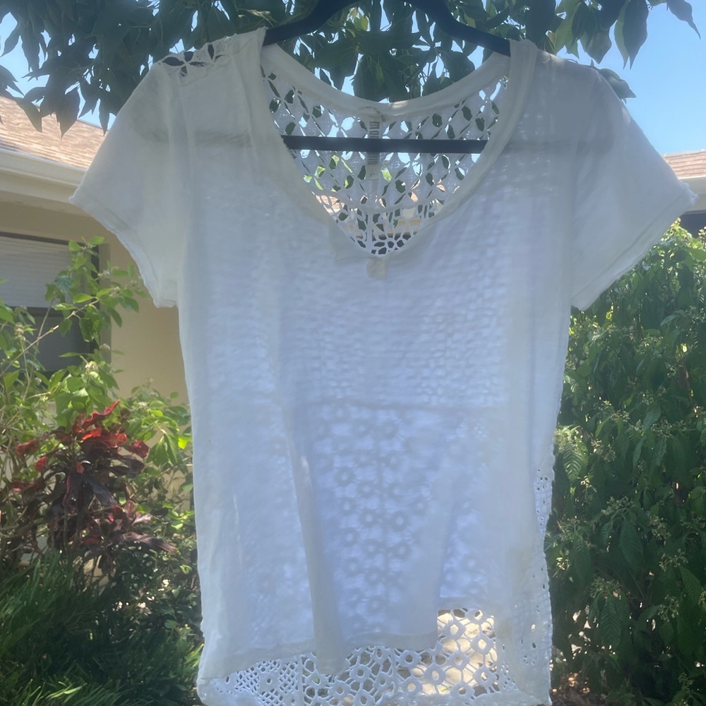 Delicate white cotton shirt with crochet back.